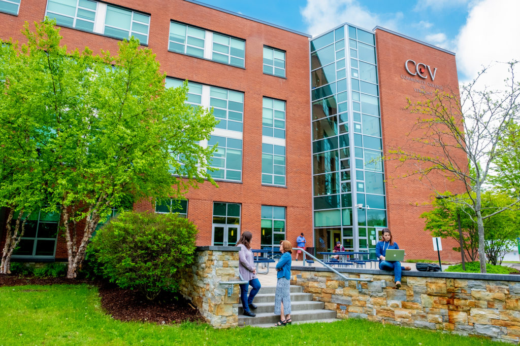 CCV Winooski Campus brick building with students in foreground